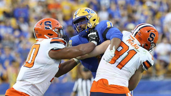 Nov 5, 2022; Pittsburgh, Pennsylvania, USA;  Syracuse Orange offensive lineman Enrique Cruz Jr. (70) and tight end Maximilian Mang (81) block Pittsburgh Panthers defensive lineman Habakkuk Baldonado (87) at the line of scrimmage during the third quarter at Acrisure Stadium. Mandatory Credit: Charles LeClaire-Imagn Images