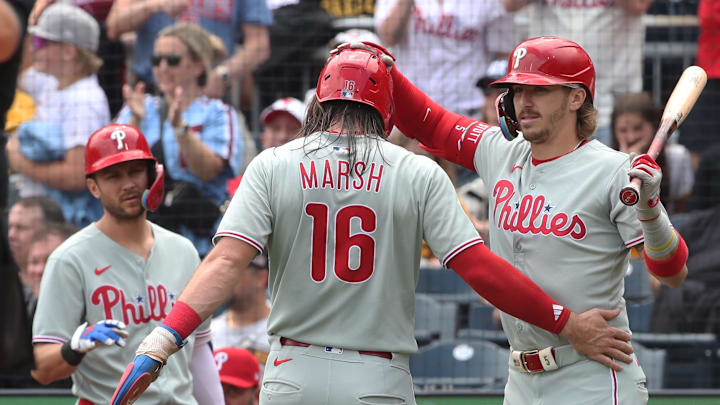 Jun 8, 2025; Pittsburgh, Pennsylvania, USA; Philadelphia Phillies shortstop Trea Turner (left) and second baseman Bryson Stott (5right congratulate center fielder Brandon Marsh (16) on scoring a run on a Pittsburgh Pirates error during the third inning at PNC Park. 