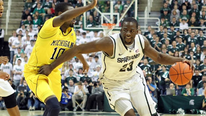February 5, 2012; East Lansing, MI, USA; Michigan State Spartans forward Draymond Green (23) drives the lane against Michigan Wolverine guard Tim Hardaway Jr. (10) during the second half at Jack Breslin Students Events Center. MSU won 64-54.   Mandatory Credit: Mike Carter-Imagn Images