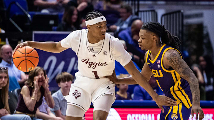 Mar 8, 2025; Baton Rouge, Louisiana, USA;  Texas A&M Aggies guard Zhuric Phelps (1) dribbles against LSU Tigers guard Jordan Sears (1) during the first half at Pete Maravich Assembly Center. Mandatory Credit: Stephen Lew-Imagn Images