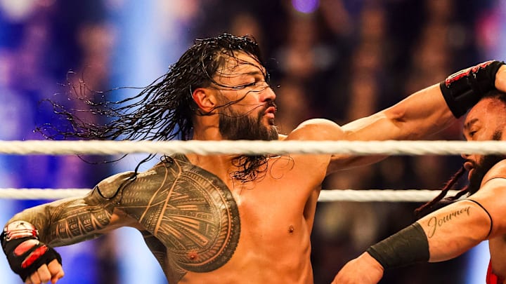 Roman Reigns throws a punch at Jacob Fatu (right) on Saturday, Feb. 1, 2025, during the WWE Royal Rumble at Lucas Oil Stadium in Indianapolis.