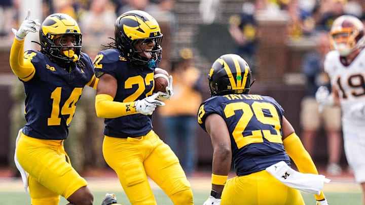 Michigan defensive back Jyaire Hill (20), center, celebrates an interception against Central Michigan with teammate during the second half at Michigan Stadium in Ann Arbor on Saturday, Sept. 13, 2025.