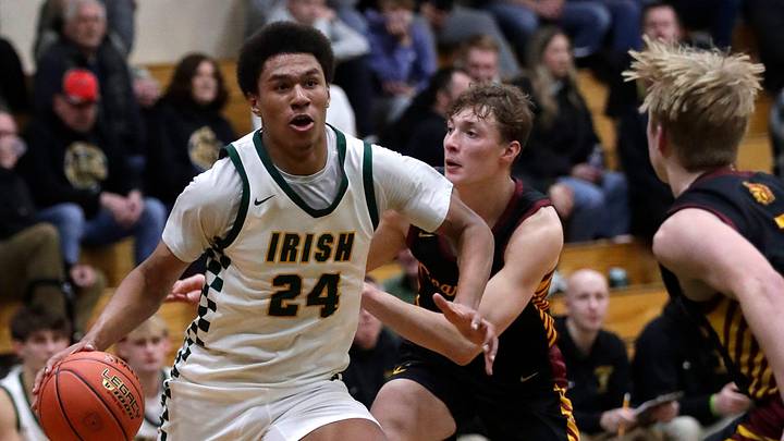 Freedom High School's Donovan Davis (24) drives to the basket against Luxemburg-Casco High School's Mason Trimberger (12) and Tatem Klaubauf (1) during their boys basketball game Thursday, February 12, 2026, in Freedom. Freedom won 89-48.