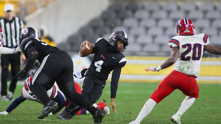 Aliquippa's Quentin Goode (4) attempts to juke McKeesport's Kemon Spell (20) during the first half of the WPIAL 4A Championship game Friday evening at Acrisure Stadium in Pittsburgh, PA.