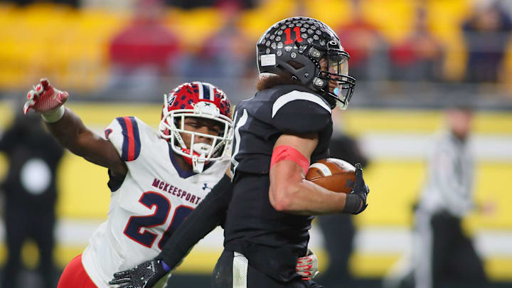 Aliquippa's Cameron Lindsey (11) pushes away from McKeesport's Kemon Spell (20) during the first half of the WPIAL 4A Championship game Friday evening at Acrisure Stadium in Pittsburgh, PA. Aliquippa's Cameron Lindsey (11) pushes away from McKeesport's Kemon Spell (20) during the first half of the WPIAL 4A Championship game Friday evening at Acrisure Stadium in Pittsburgh, PA.