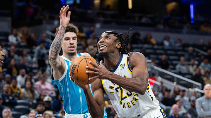 Oct 17, 2024; Indianapolis, Indiana, USA; Indiana Pacers forward Aaron Nesmith (23) shoots the ball while Charlotte Hornets guard LaMelo Ball (1) defends in the first half at Gainbridge Fieldhouse. Mandatory Credit: Trevor Ruszkowski-Imagn Images Oct 17, 2024; Indianapolis, Indiana, USA; Indiana Pacers forward Aaron Nesmith (23) shoots the ball while Charlotte Hornets guard LaMelo Ball (1) defends in the first half at Gainbridge Fieldhouse. Mandatory Credit: Trevor Ruszkowski-Imagn Images