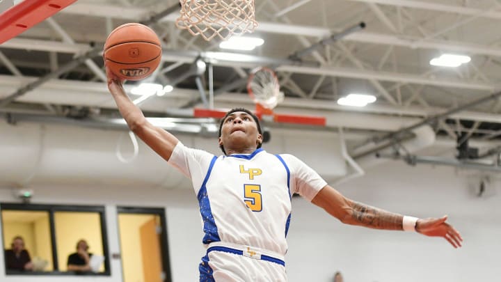 Lincoln Park s Meleek Thomas goes in for a layup against North Catholic s Jude Rottmann during a PIAA Class 4A quarterfinal game, Friday at Fox Chapel High School. Lincoln Park s Meleek Thomas goes in for a layup against North Catholic s Jude Rottmann during a PIAA Class 4A quarterfinal game, Friday at Fox Chapel High School.