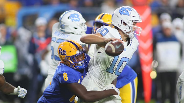 North Carolina Tar Heels Drake Maye (10) gets sacked by Pittsburgh Panthers Samuel Okunlola (8) during the first half at Acrisure Stadium in Pittsburgh, PA on September 23, 2023.
