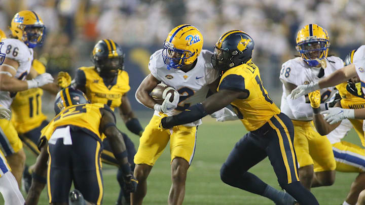 Pittsburgh Panthers Kenny Johnson (2) gets tackled by West Virginia Mountaineers Trey Lathan (19) during the second half at Milan Puskar Stadium in Morgantown, WV on September 16, 2023. Pittsburgh Panthers Kenny Johnson (2) gets tackled by West Virginia Mountaineers Trey Lathan (19) during the second half at Milan Puskar Stadium in Morgantown, WV on September 16, 2023.