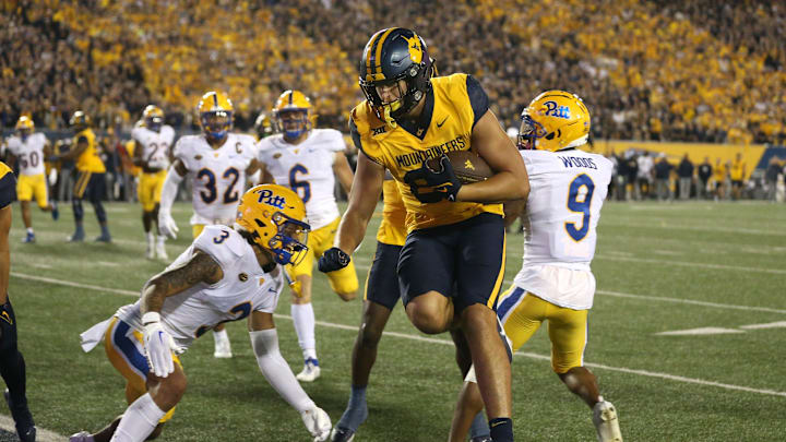 West Virginia Mountaineers Kole Taylor (87) leaps around Pittsburgh Panthers Donovan McMillon (3) for a touchdown during the first half at Milan Puskar Stadium in Morgantown, WV on September 16, 2023.