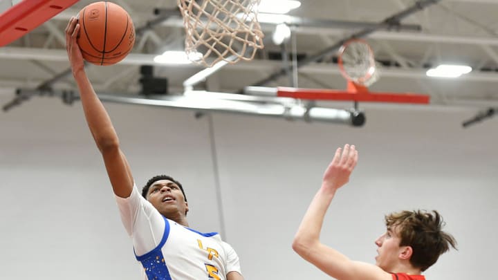 Lincoln Park   s Meleek Thomas goes in for a layup against North Catholic   s Jude Rottmann during a