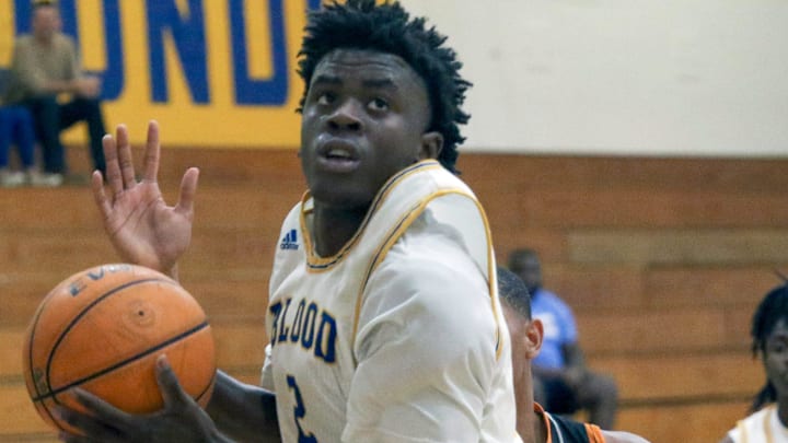 Auburndale's Kervan Knaggs pulls down a rebound against Lake Wales on Wednesday in the semifinals of the Class 5A, District 7 boys basketball tournament at the Tracy McGrady Gymnasium.