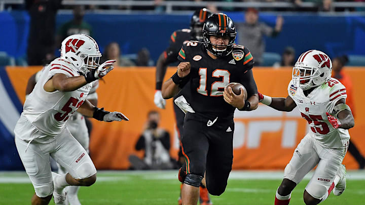 Dec 30, 2017; Miami Gardens, FL, USA; Miami Hurricanes quarterback Malik Rosier (12) runs the ball against the Wisconsin Badgers during the first half in the 2017 Orange Bowl at Hard Rock Stadium. Mandatory Credit: Jasen Vinlove-Imagn Images