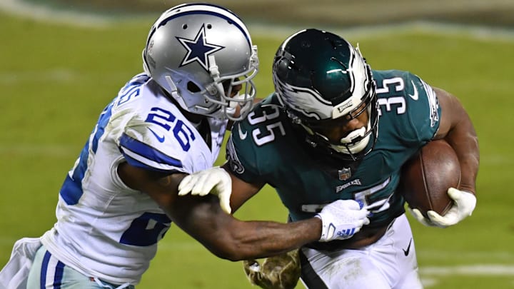 Nov 1, 2020; Philadelphia, Pennsylvania, USA; Philadelphia Eagles running back Boston Scott (35) is tackled by Dallas Cowboys cornerback Jourdan Lewis (26) during the third quarter at Lincoln Financial Field. Mandatory Credit: Eric Hartline-Imagn Images
