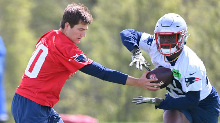 May 11, 2024; Foxborough, MA, USA; New England Patriots quarterback Drake Maye (10) hands the ball to running back Terrell Jennings  (29) at the New England Patriots rookie camp at Gillette Stadium.  Mandatory Credit: Eric Canha-Imagn Images