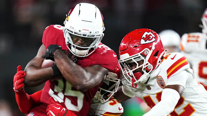 Arizona Cardinals running back Bam Knight (35) tries to break away from Kansas City Chiefs defenders Jaylen Watson (35) and Azizi Hearn (42) during their preseason game at State Farm Stadium on Aug. 9, 2025. Arizona Cardinals running back Bam Knight (35) tries to break away from Kansas City Chiefs defenders Jaylen Watson (35) and Azizi Hearn (42) during their preseason game at State Farm Stadium on Aug. 9, 2025.