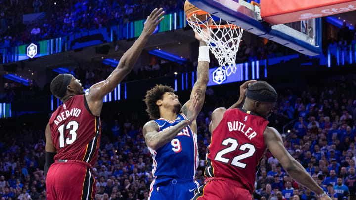 Apr 17, 2024; Philadelphia, Pennsylvania, USA; Philadelphia 76ers guard Kelly Oubre Jr. (9) drives for a score past Miami Heat center Bam Adebayo (13) and forward Jimmy Butler (22) during the fourth quarter of a play-in game of the 2024 NBA playoffs at Wells Fargo Center. Mandatory Credit: Bill Streicher-USA TODAY Sports Apr 17, 2024; Philadelphia, Pennsylvania, USA; Philadelphia 76ers guard Kelly Oubre Jr. (9) drives for a score past Miami Heat center Bam Adebayo (13) and forward Jimmy Butler (22) during the fourth quarter of a play-in game of the 2024 NBA playoffs at Wells Fargo Center. Mandatory Credit: Bill Streicher-USA TODAY Sports