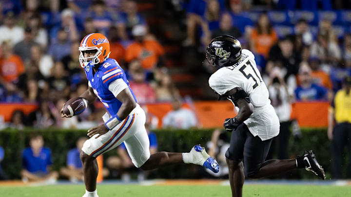 Oct 5, 2024; Gainesville, Florida, USA; Florida Gators quarterback DJ Lagway (2) runs from UCF Knights defensive end Malachi Lawrence (51) during the second half at Ben Hill Griffin Stadium. Mandatory Credit: Matt Pendleton-Imagn Images