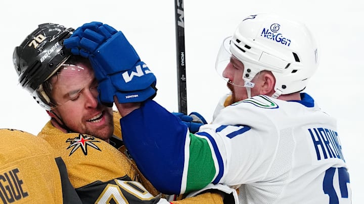 Feb 22, 2025; Las Vegas, Nevada, USA; Vancouver Canucks defenseman Filip Hronek (17) grabs the visor of Vegas Golden Knights left wing Tanner Pearson (70) during the third period at T-Mobile Arena. Mandatory Credit: Stephen R. Sylvanie-Imagn Images