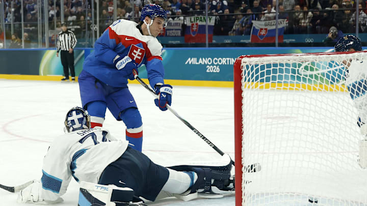 Feb 11, 2026; Milan, Italy;  Juraj Slafkovsky of Slovakia scores their first goal past Juuse Saros of Finland in men's ice hockey group B play during the Milano Cortina 2026 Olympic Winter Games at Milano Santagiulia Ice Hockey Arena. Mandatory Credit: Geoff Burke-Imagn Images