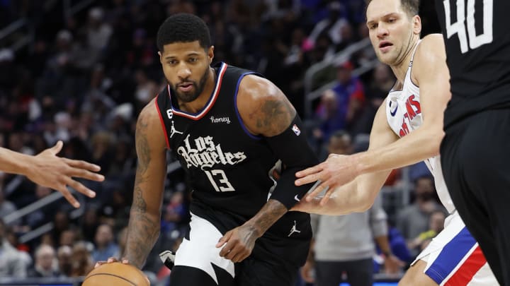 Dec 26, 2022; Detroit, Michigan, USA;  LA Clippers guard Paul George (13) dribbles defended by Detroit Pistons forward Bojan Bogdanovic (44) in the second half at Little Caesars Arena. Mandatory Credit: Rick Osentoski-USA TODAY Sports