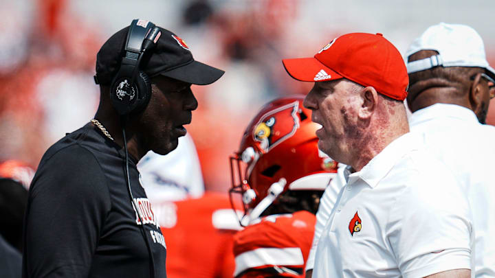 Louisville football head coach Jeff Brohm, right, talks with defense coordinator Ron English as the Cards take on Bowling Green in football Saturday, Sept. 20, 2025, in Louisville, Kentucky