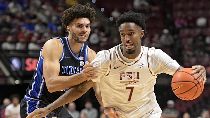 Jan 3, 2026; Tallahassee, Florida, USA; Duke Blue Devils forward Cameron Boozer (12) defends Florida State Seminoles forward Chauncey Wiggins (7) during the first half at Donald L. Tucker Center. Mandatory Credit: Melina Myers-Imagn Images