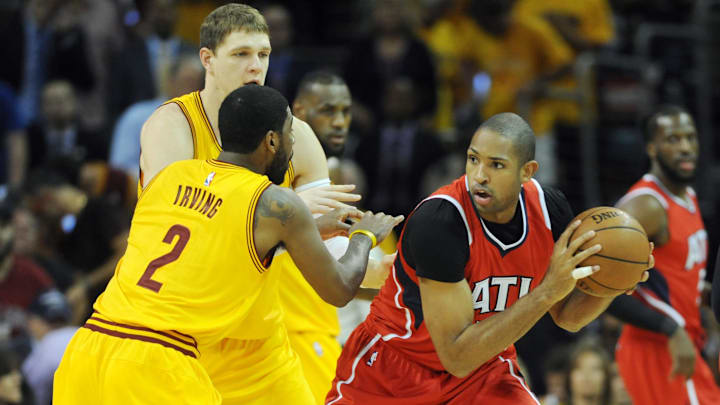 May 26, 2015; Cleveland, OH, USA; Atlanta Hawks center Al Horford (15) handles the ball against Cleveland Cavaliers guard Kyrie Irving (2) during the first quarter in game four of the Eastern Conference Finals of the NBA Playoffs at Quicken Loans Arena. Mandatory Credit: Ken Blaze-Imagn Images
