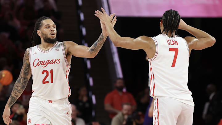 Feb 14, 2026; Houston, Texas, USA; Houston Cougars guard Emanuel Sharp (21) celebrates guard Milos Uzan (7) three point basket against the Kansas State Wildcats in the first half at Fertitta Center. Mandatory Credit: Thomas Shea-Imagn Images