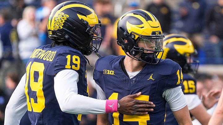 Michigan quarterback Tommy Carr (14) hugs quarterback Bryce Underwood (19) during warmup ahead of the game between Michigan and Indiana at Michigan Stadium in Ann Arbor on Saturday, Oct. 24, 2026. Michigan quarterback Tommy Carr (14) hugs quarterback Bryce Underwood (19) during warmup ahead of the game between Michigan and Indiana at Michigan Stadium in Ann Arbor on Saturday, Oct. 24, 2026.