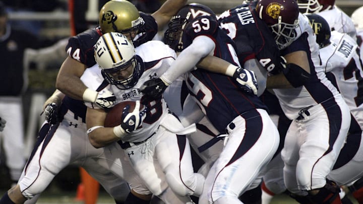 Jan 26, 2008; Mobile, AL USA;  South squad running back Jacob Hester (18) of LSU is tackled by North squad linebacker Jordan Dizon (44) of Colorado and lineman Chris Ellis (50) of Virginia Tech during the second half of the Senior Bowl at Lad-Peebles Stadium in Mobile, Ala.  