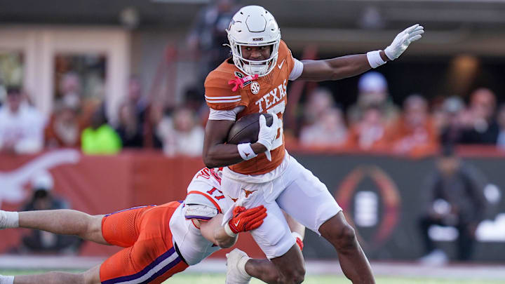 Texas Longhorns wide receiver Ryan Wingo runs for yardage against Clemson Tigers linebacker Wade Woodaz. Texas Longhorns wide receiver Ryan Wingo runs for yardage against Clemson Tigers linebacker Wade Woodaz.