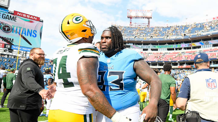 Sep 22, 2024; Nashville, Tennessee, USA;  Green Bay Packers guard Elgton Jenkins (74) and Tennessee Titans defensive tackle T'Vondre Sweat (93) during post game during the second half at Nissan Stadium. Mandatory Credit: Steve Roberts-Imagn Images