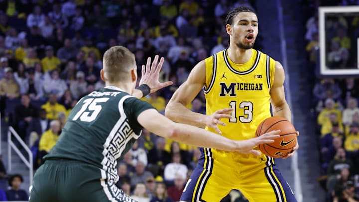Feb 17, 2024; Ann Arbor, Michigan, USA;  Michigan Wolverines forward Olivier Nkamhoua (13) dribbles