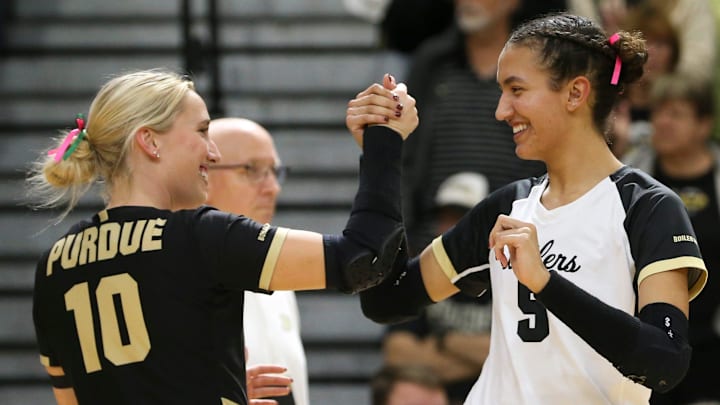 Purdue defensive specialist Ali Hornung (10) and Purdue setter Taylor Anderson (5) celebrate 