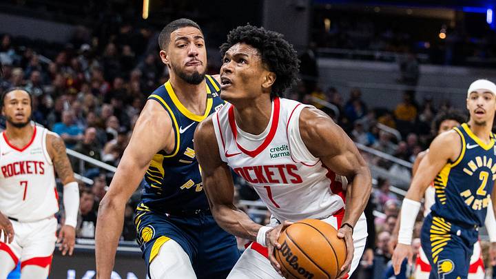 Feb 6, 2024; Indianapolis, Indiana, USA; Houston Rockets forward Amen Thompson (1) shoots the ball while Indiana Pacers guard Tyrese Haliburton (0) defends in the first half at Gainbridge Fieldhouse. Mandatory Credit: Trevor Ruszkowski-USA TODAY Sports