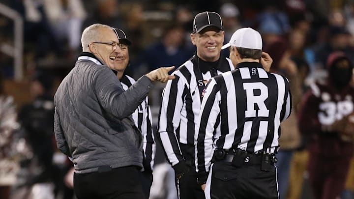 Nov 23, 2023; Starkville, Mississippi, USA; Southeastern Conference commissioner Greg Sankey (left) talk with officials prior to the game between the Mississippi Rebels and the Mississippi State Bulldogs at Davis Wade Stadium at Scott Field. Mandatory Credit: Petre Thomas-Imagn Images