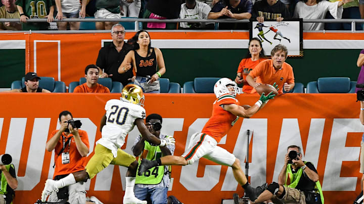 Nov 11, 2017; Miami Gardens, FL, USA; Miami Hurricanes wide receiver Braxton Berrios (8) catches a pass for a touchdown in front of Notre Dame Fighting Irish cornerback Shaun Crawford (20) in the first quarter at Hard Rock Stadium. Mandatory Credit: Matt Cashore-Imagn Images