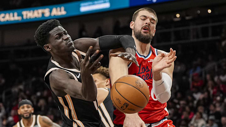 Dec 3, 2025; Atlanta, Georgia, USA; Atlanta Hawks forward Mouhamed Gueye (18) and LA Clippers center Ivica Zubac (40) fight for a rebound during the second half at State Farm Arena. Mandatory Credit: Dale Zanine-Imagn Images