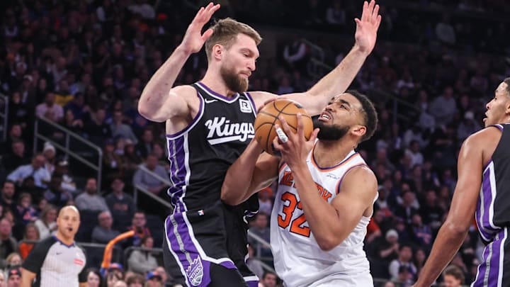 Jan 25, 2025; New York, New York, USA;  New York Knicks center Karl-Anthony Towns (32) posts up against Sacramento Kings forward Domantas Sabonis (11) in the second quarter at Madison Square Garden. Mandatory Credit: Wendell Cruz-Imagn Images