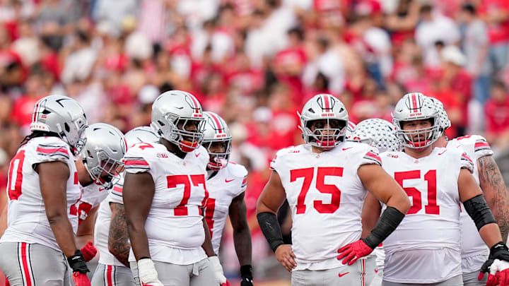 Ohio State Buckeyes offensive linemen Tegra Tshabola (77), Carson Hinzman (75) and Luke Montgomery (51) wait for the ball to be put in play in the second half at Camp Randall Stadium on Saturday, Oct. 18, 2025 in Madison, Wisconsin. Ohio State Buckeyes offensive linemen Tegra Tshabola (77), Carson Hinzman (75) and Luke Montgomery (51) wait for the ball to be put in play in the second half at Camp Randall Stadium on Saturday, Oct. 18, 2025 in Madison, Wisconsin.