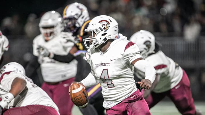 Dougherty   s quarterback Kameron Davis scrambles in the pocket to avoid a sack from the Cavaliers  