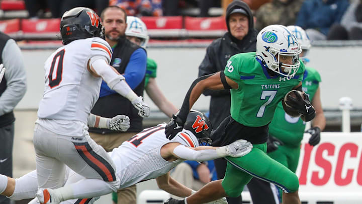 Green Bay Notre Dame's Kingston Allen (7) is forced out of bounds by West De Pere High School's Cooper Borowicz (21) during the WIAA Division 2 state championship football game on Friday, November 21, 2025, at Camp Randall Stadium in Madison, Wis. 
Tork Mason/USA TODAY NETWORK-Wisconsin