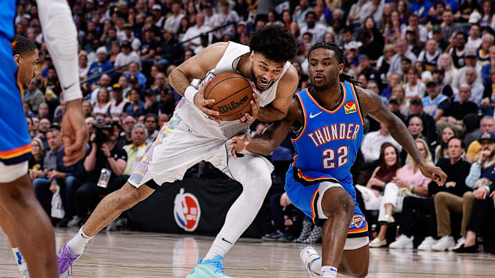 May 15, 2025; Denver, Colorado, USA; Denver Nuggets guard Jamal Murray (27) drives to the net against Oklahoma City Thunder guard Cason Wallace (22) in the fourth quarter during game six of the second round for the 2025 NBA Playoffs at Ball Arena. Mandatory Credit: Isaiah J. Downing-Imagn Images