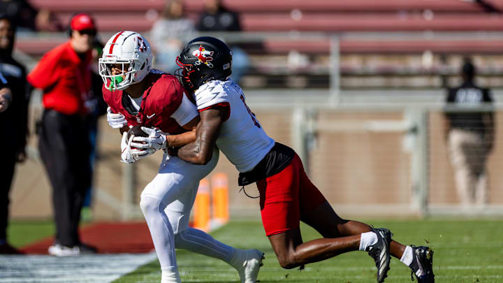 Nov 16, 2024; Stanford, California, USA; Stanford Cardinal wide receiver Emmett Mosley V (10) is tackled out of bounds during the first quarter against the Louisville Cardinals at Stanford Stadium. Mandatory Credit: Bob Kupbens-Imagn Images