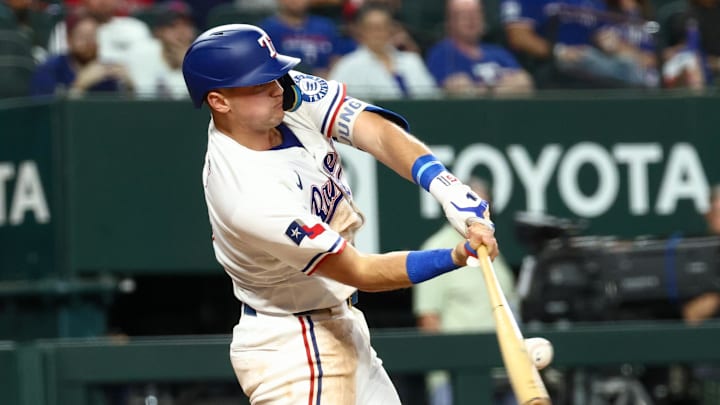 Aug 26, 2025; Arlington, Texas, USA; Texas Rangers third baseman Josh Jung (6) hits an rbi single against the Los Angeles Angels during the first inning at Globe Life Field. Mandatory Credit: Kevin Jairaj-Imagn Images