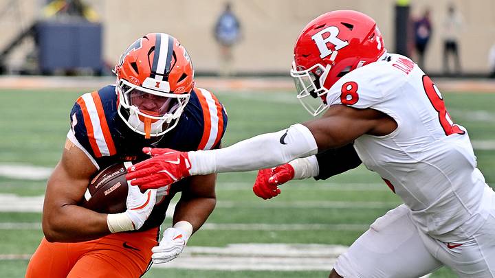 Nov 1, 2025; Champaign, Illinois, USA;  Rutgers Scarlet Knights linebacker Dariel Djabome (8) tackles Illinois Fighting Illini running back Kaden Feagin (3) during the first half at Memorial Stadium. Mandatory Credit: Ron Johnson-Imagn Images