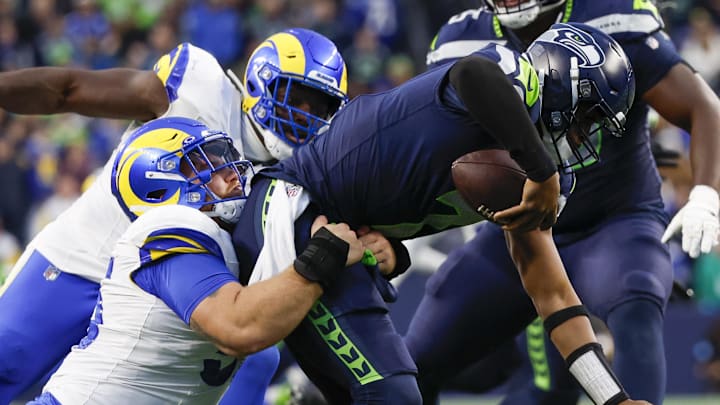 Nov 3, 2024; Seattle, Washington, USA; Los Angeles Rams defensive tackle Braden Fiske (55) sacks Seattle Seahawks quarterback Geno Smith (7) during the fourth quarter at Lumen Field. Mandatory Credit: Joe Nicholson-Imagn Images