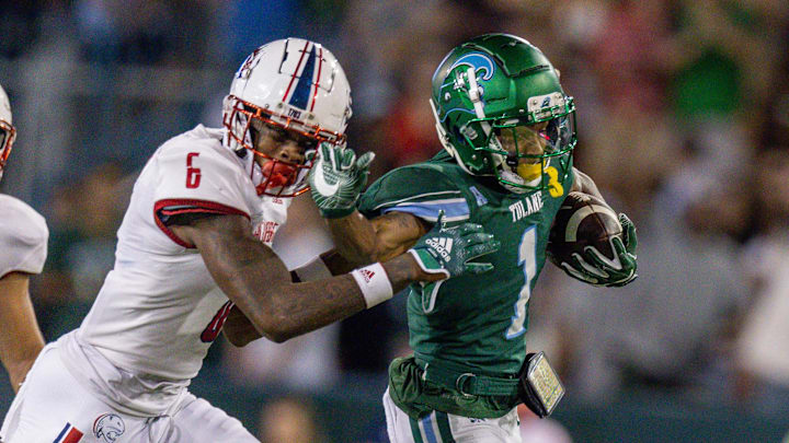Tulane receiver Dontae Fleming stiff-arms South Alabama cornerback Ricky Fletcher during a game last season.