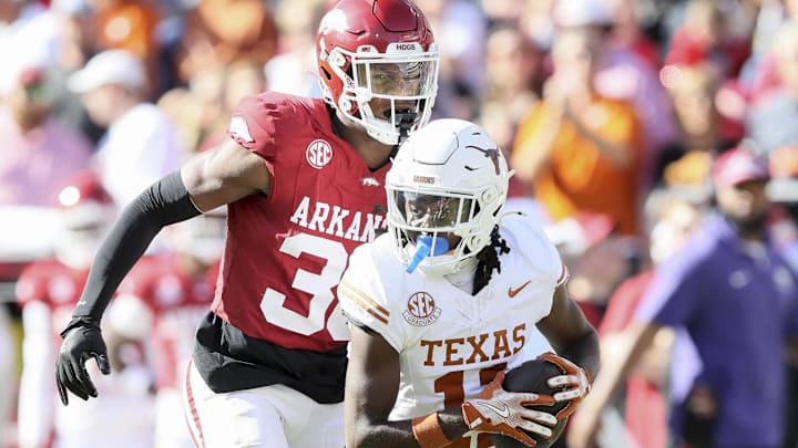 Nov 16, 2024; Fayetteville, Arkansas, USA; Texas Longhorns wide receiver Silas Bolden (11) runs the ball in the first quarter as Arkansas Razorbacks linebacker Larry Worth III (30) defends at Donald W. Reynolds Razorback Stadium. Mandatory Credit: Nelson Chenault-Imagn Images